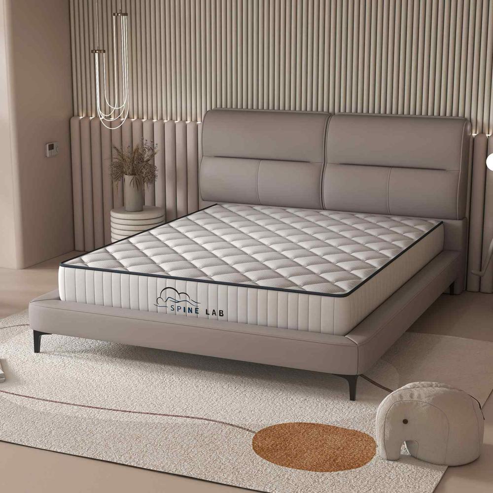 Spring Mattress on beige bedframe in bedroom - House