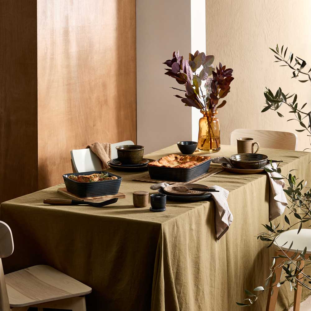 dining table with moody ribbed rustic dinnerware, bakeware, and kitchenware - House
