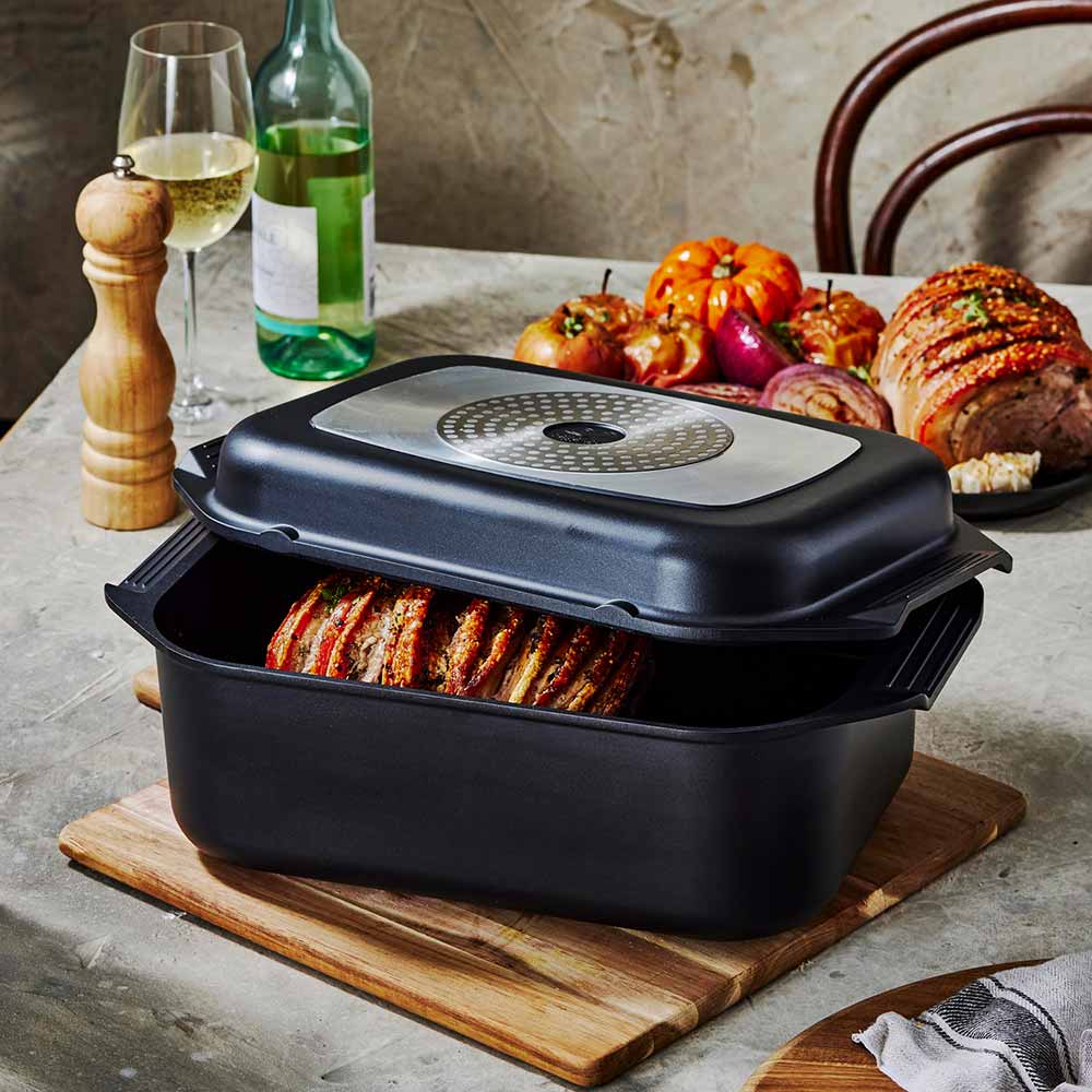 Bessemer Non Stick Roaster & Grill 34cm Black at House on a wooden board with roast pork and vegetables