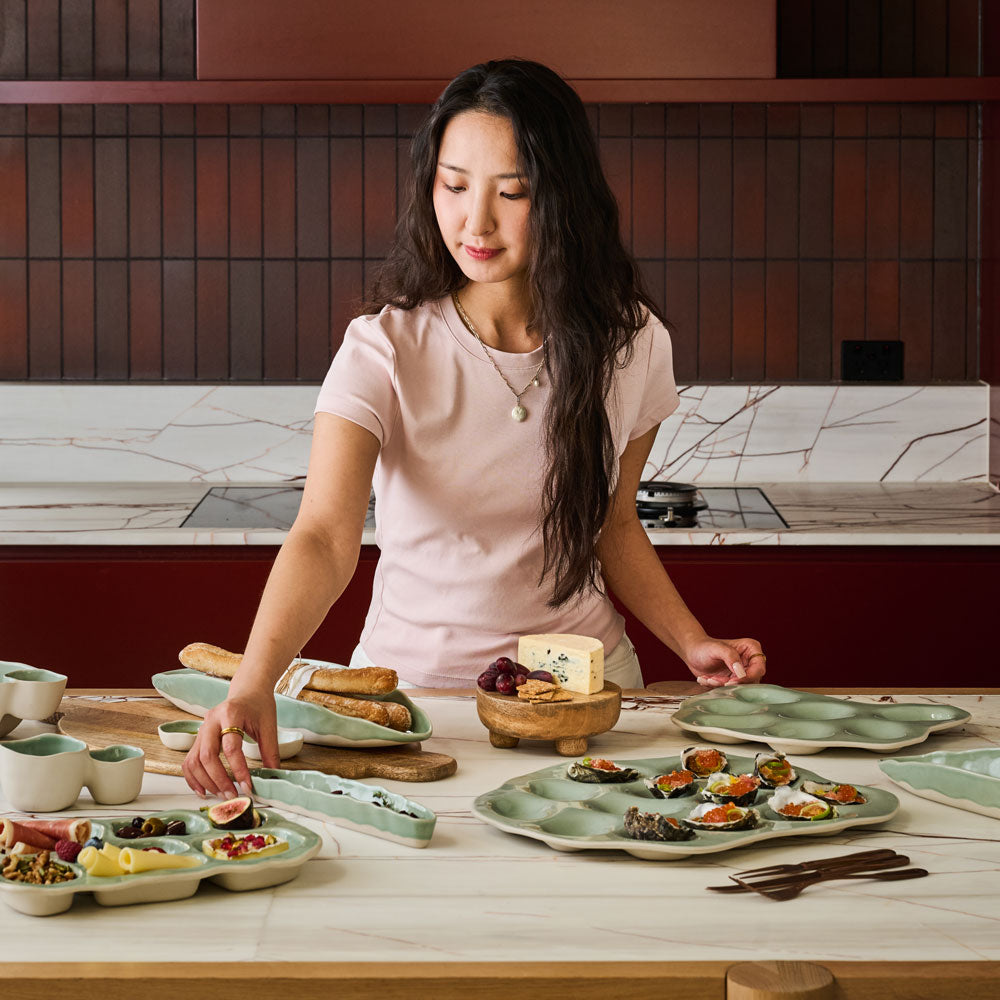 The Ecology Selvedge oyster plate on a table spread with different platters holding oysters ready to enjoy