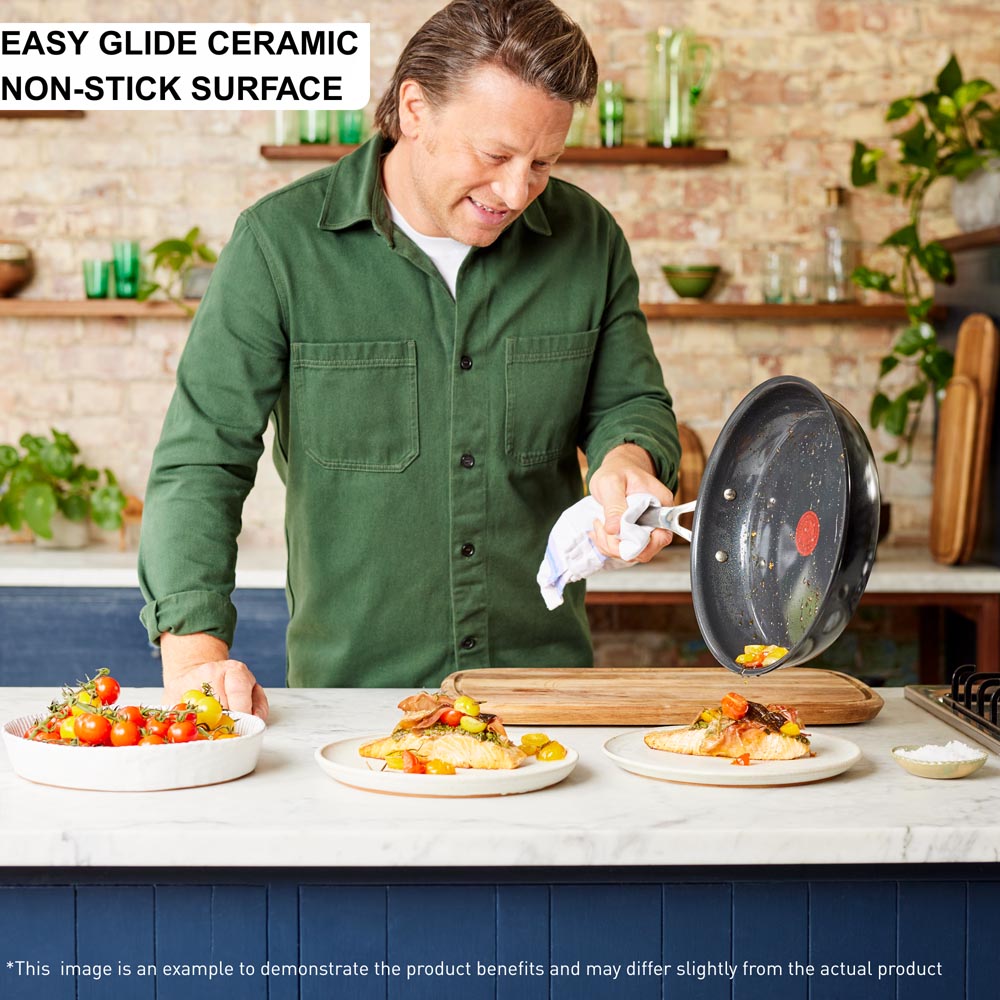 Jamie Oliver sliding food from frypan onto salmon - House