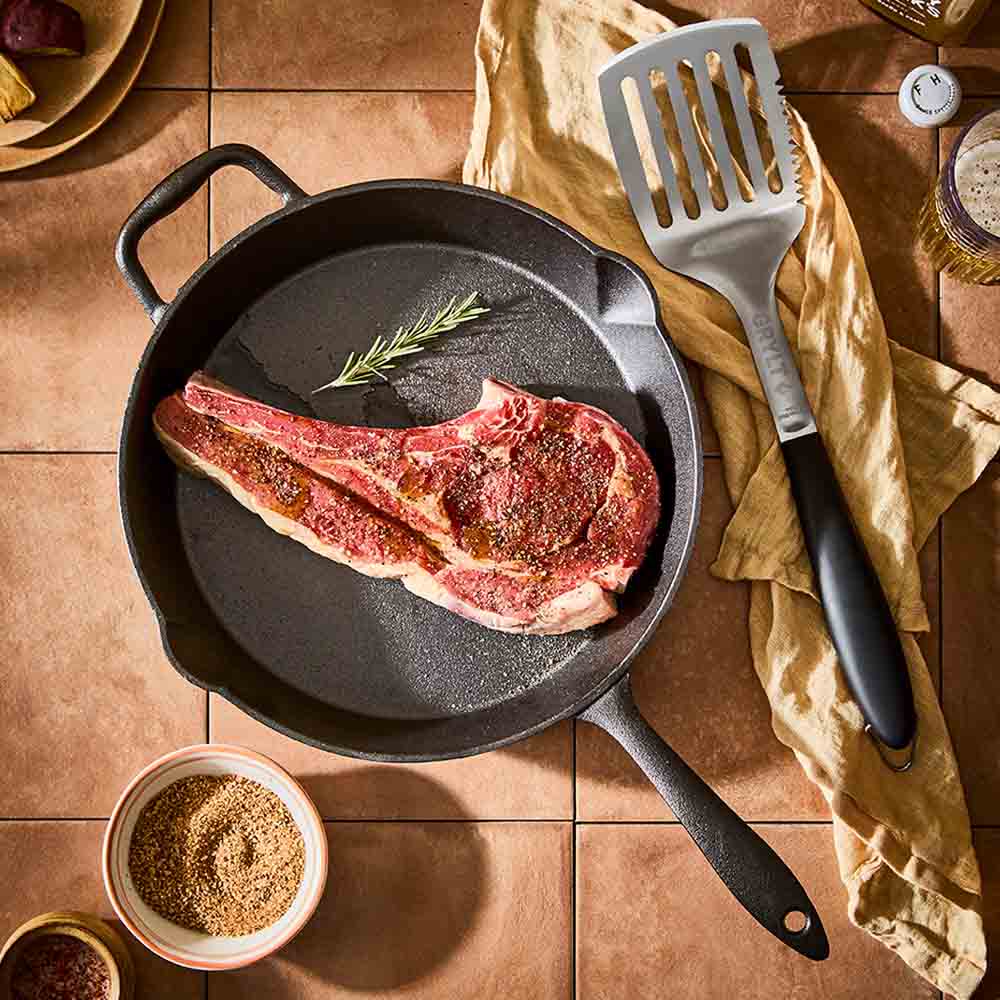 steak in a cast iron frypan with helper handle - House