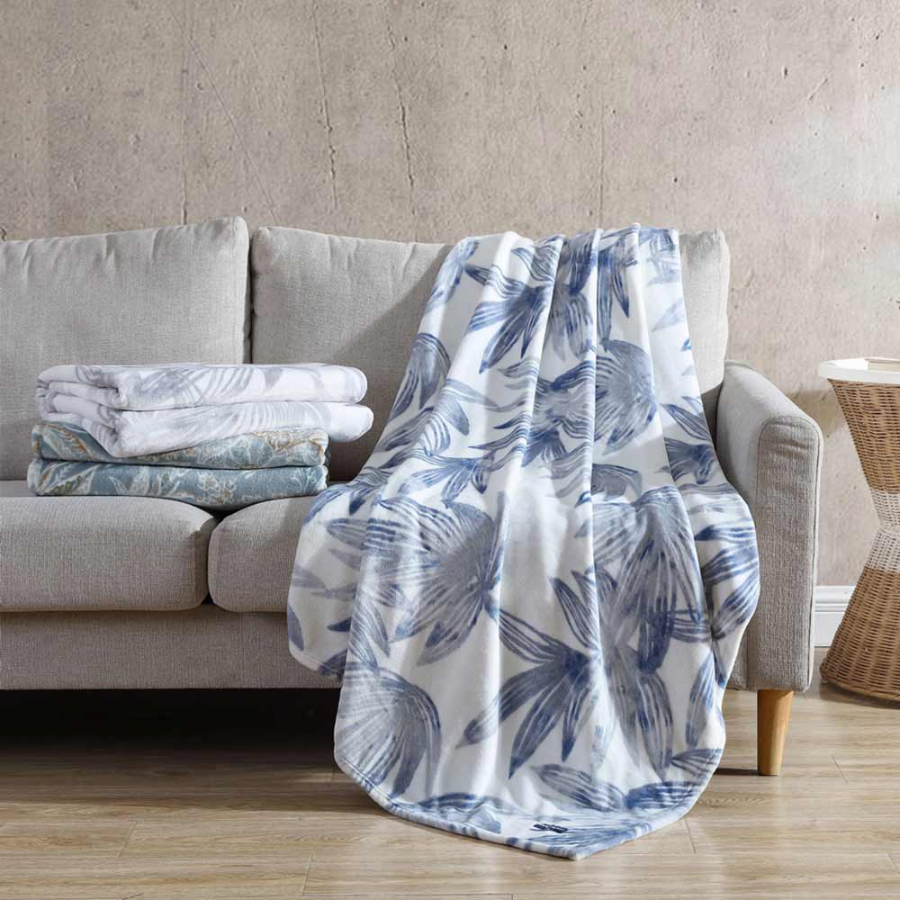 Tommy Bahama Kayo Blanket Canal Blue on a couch at House