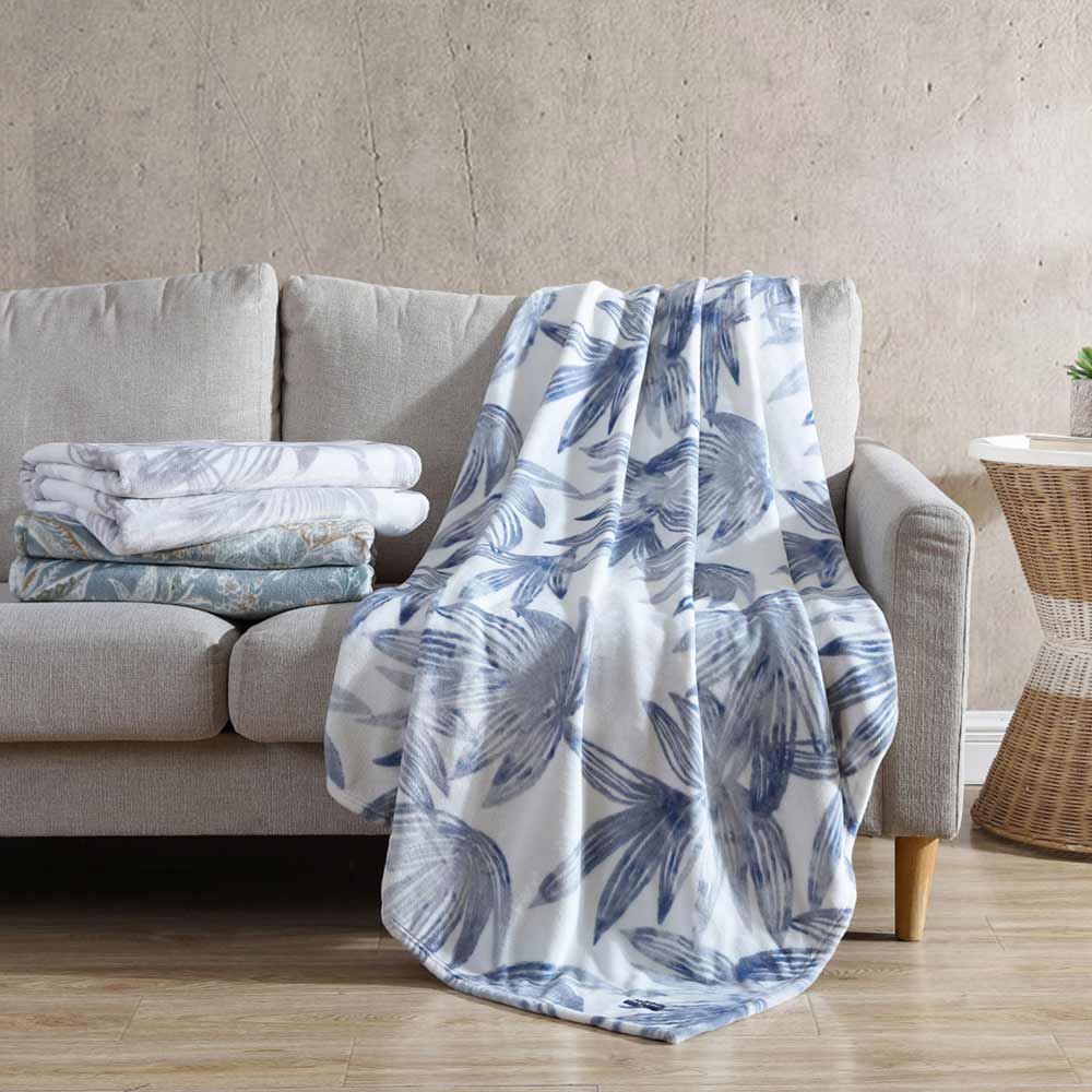 Tommy Bahama Kayo Throw Canal Blue  draped over a couch at House