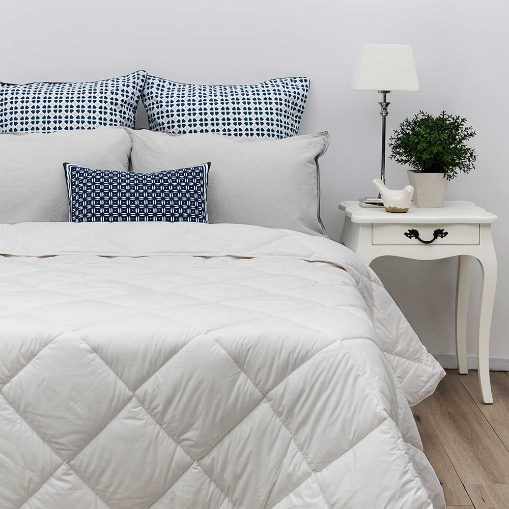 Tontine Farmhouse Lightweight Washable Wool Quilt on a bed at House