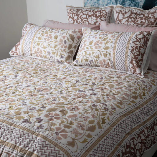 Patterned bedspread and pillows on a bed