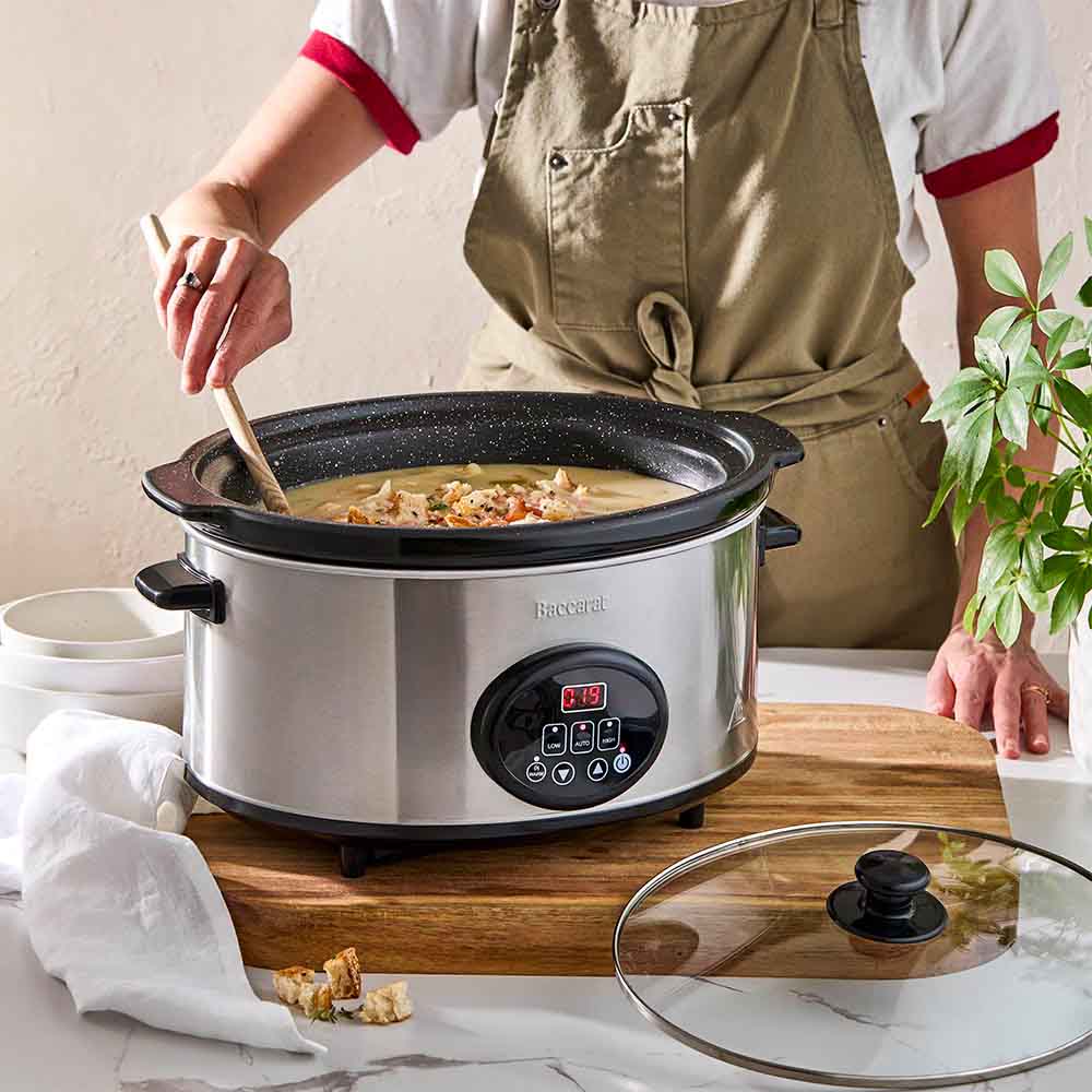 Baccarat The Tasty Chef 6L Slow Cooker at House. Woman stirring a casserole in a slow cooker.