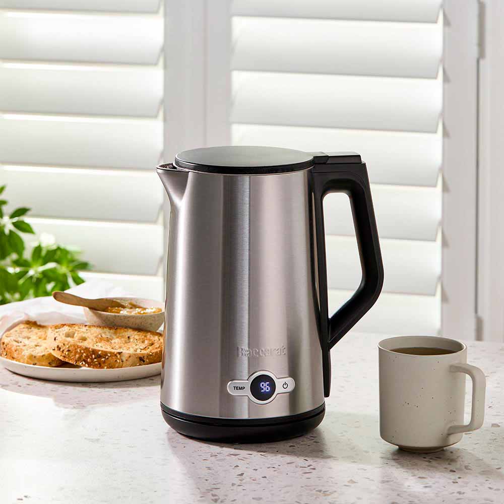 Baccarat The Boiling Point Tempcontrol Kettle in Silver at House. Silver kettle with mug of coffee and toast.