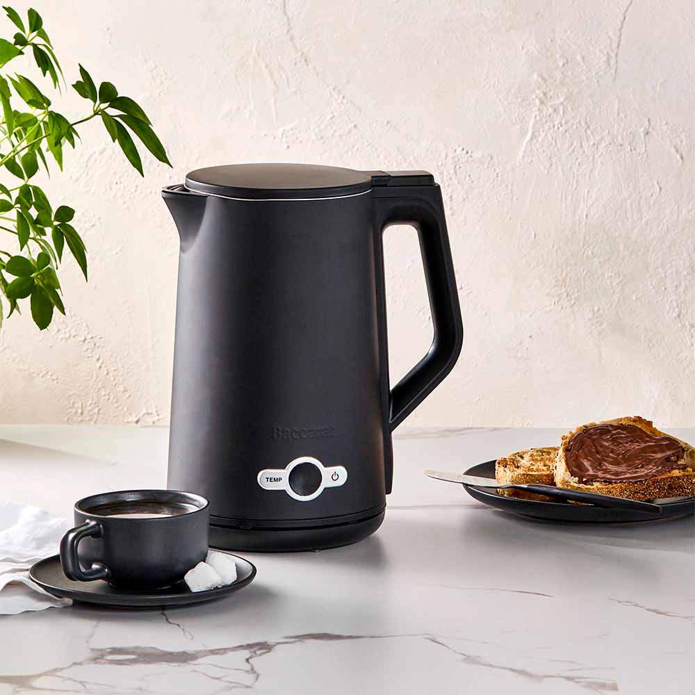 Baccarat The Boiling Point Tempcontrol Kettle in Black at House. Black kettle on a kitchen countertop with tea and toast.