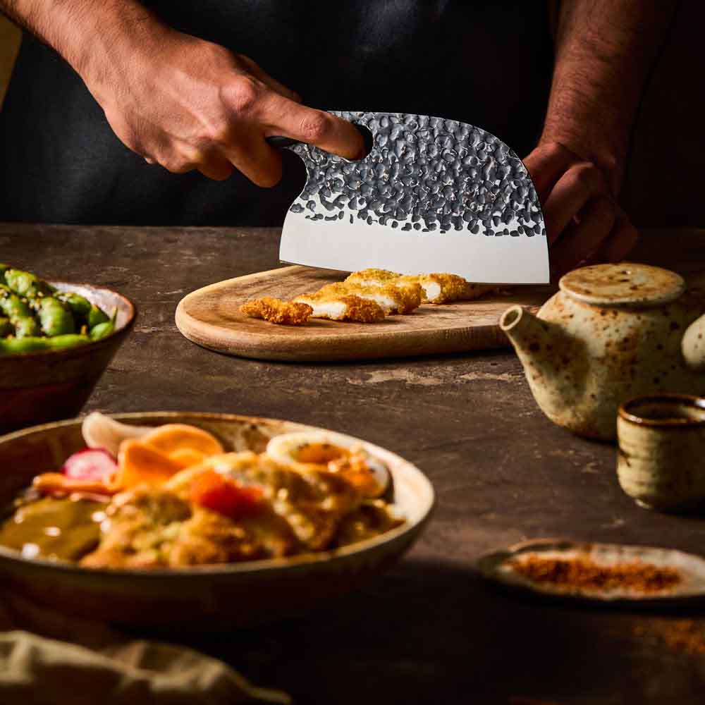 Man slicing katsu chicken with Baccarat KUROI KIBA Moon Knife 17.5cm at House