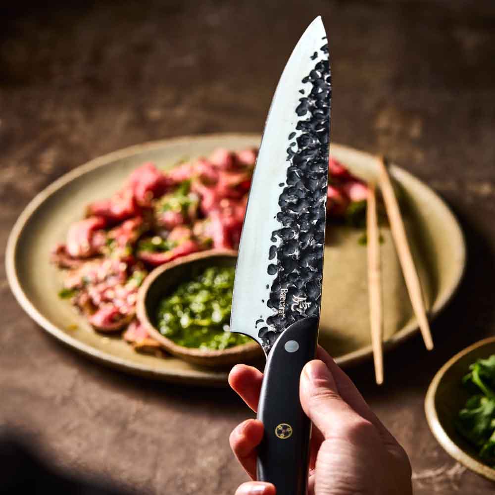 Man holding Baccarat KUROI KIBA Chefs Knife 20cm at House