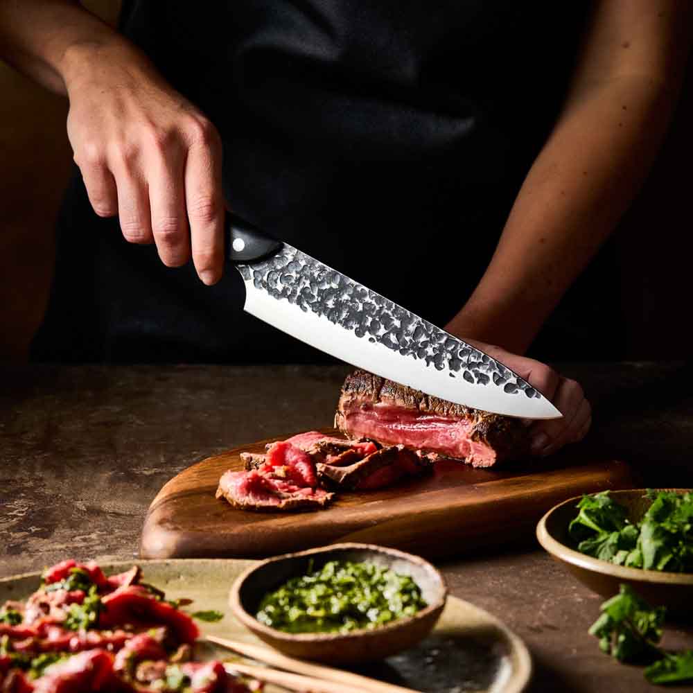 Man slicing wagyu beef with Baccarat KUROI KIBA Chefs Knife 20cm at House