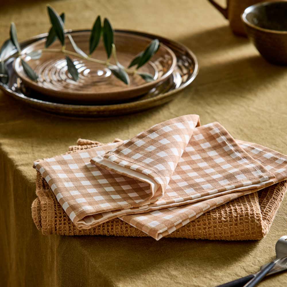 beige check tea towel and beige waffle tea towel on dining table - House