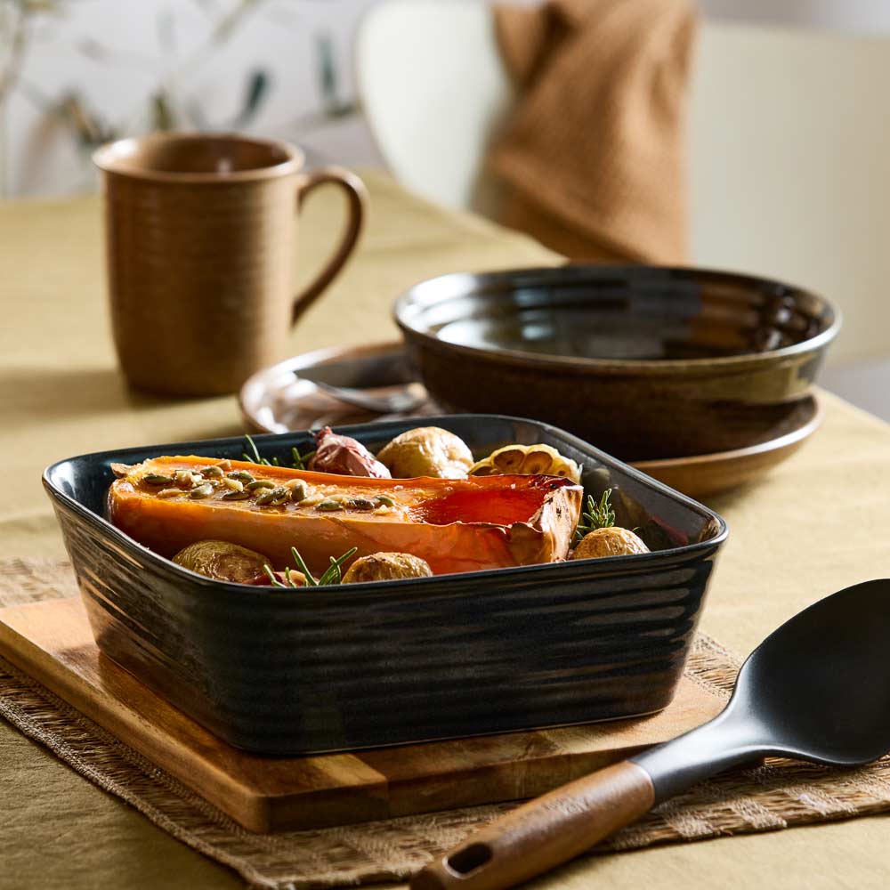 Roasted pumpkin and potatoes in navy square baking dish - House