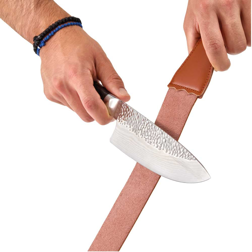 Man sharpening knife with leather strop - House