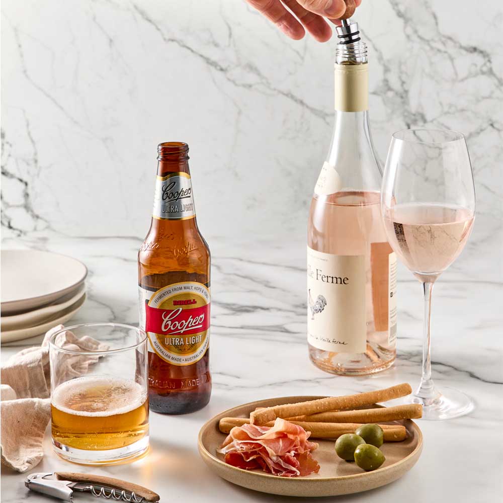 Wood Bottle Opener and Bottle Stopper next to wine & beer - House