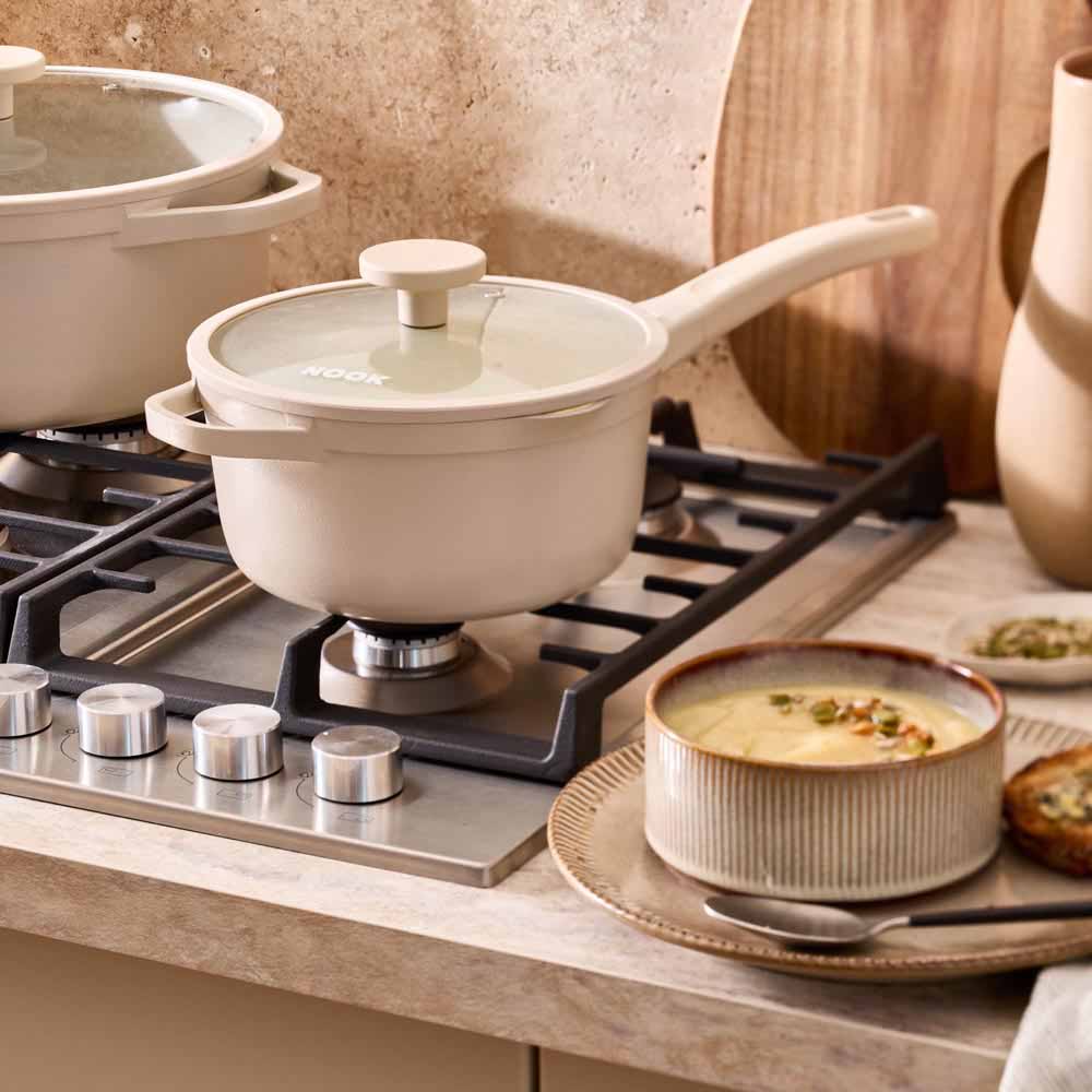 french onion soup cooking in a cream saucepan