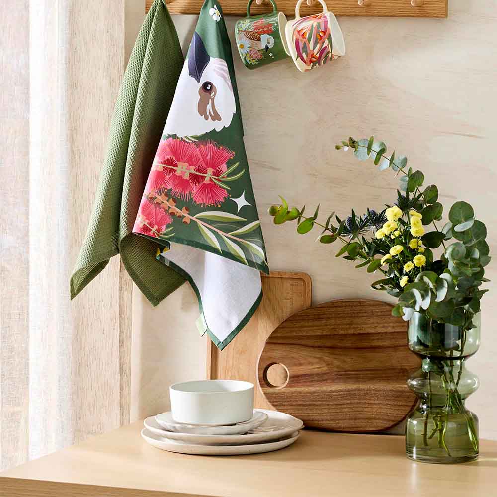 kookaburra design tea towels hanging from a wooden hook