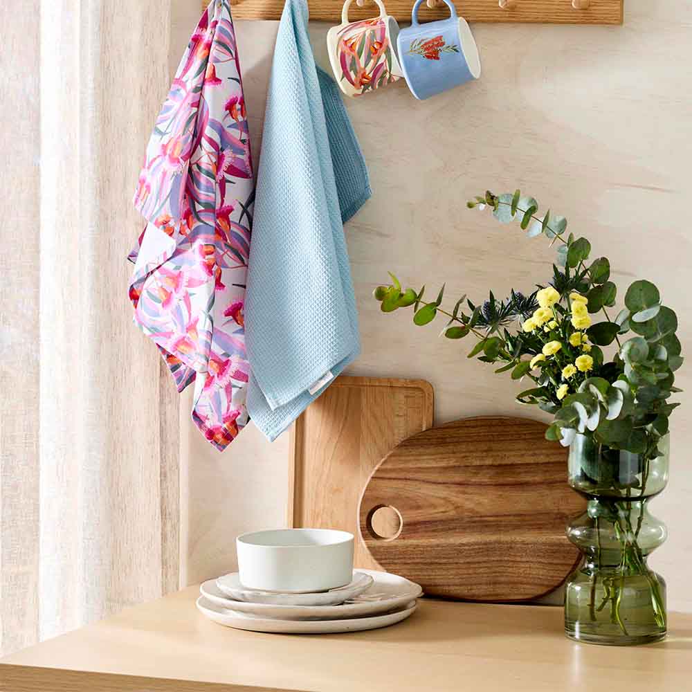 gumnut design tea towels hanging from a wooden hook