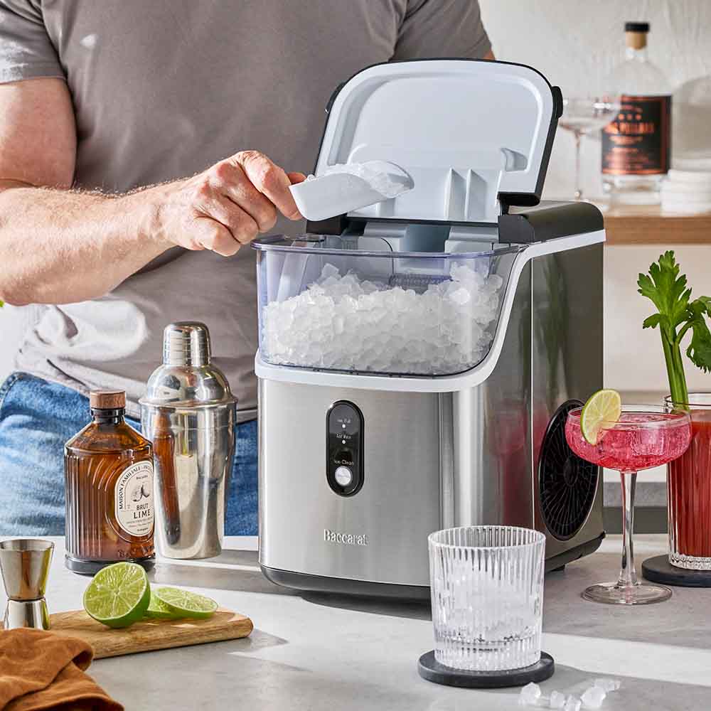 man scooping ice from an electrical ice maker