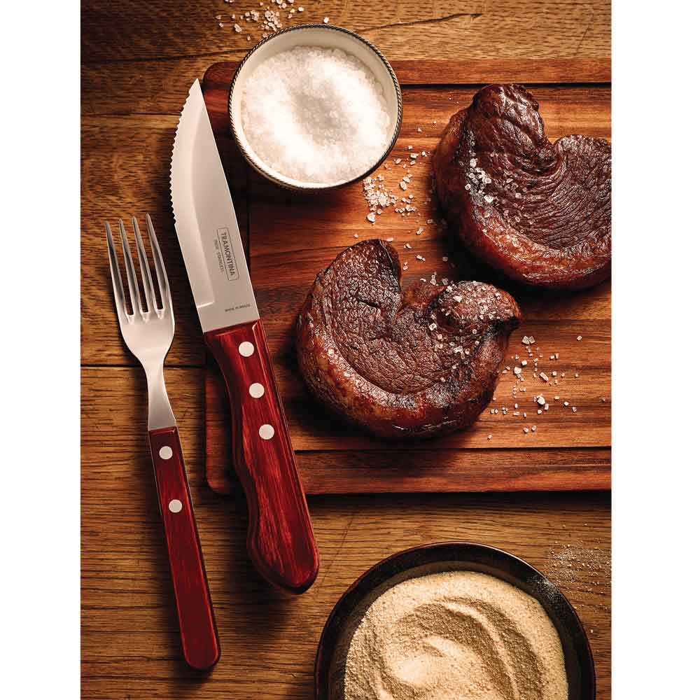 steak knife and fork set with side of steaks on wooden board - House