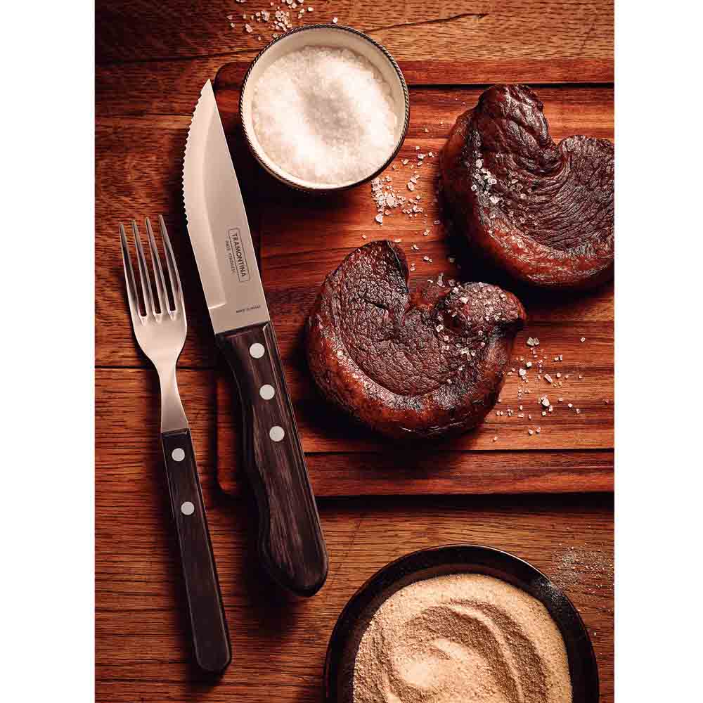 steak knife and fork set with side of steaks on wooden board - House