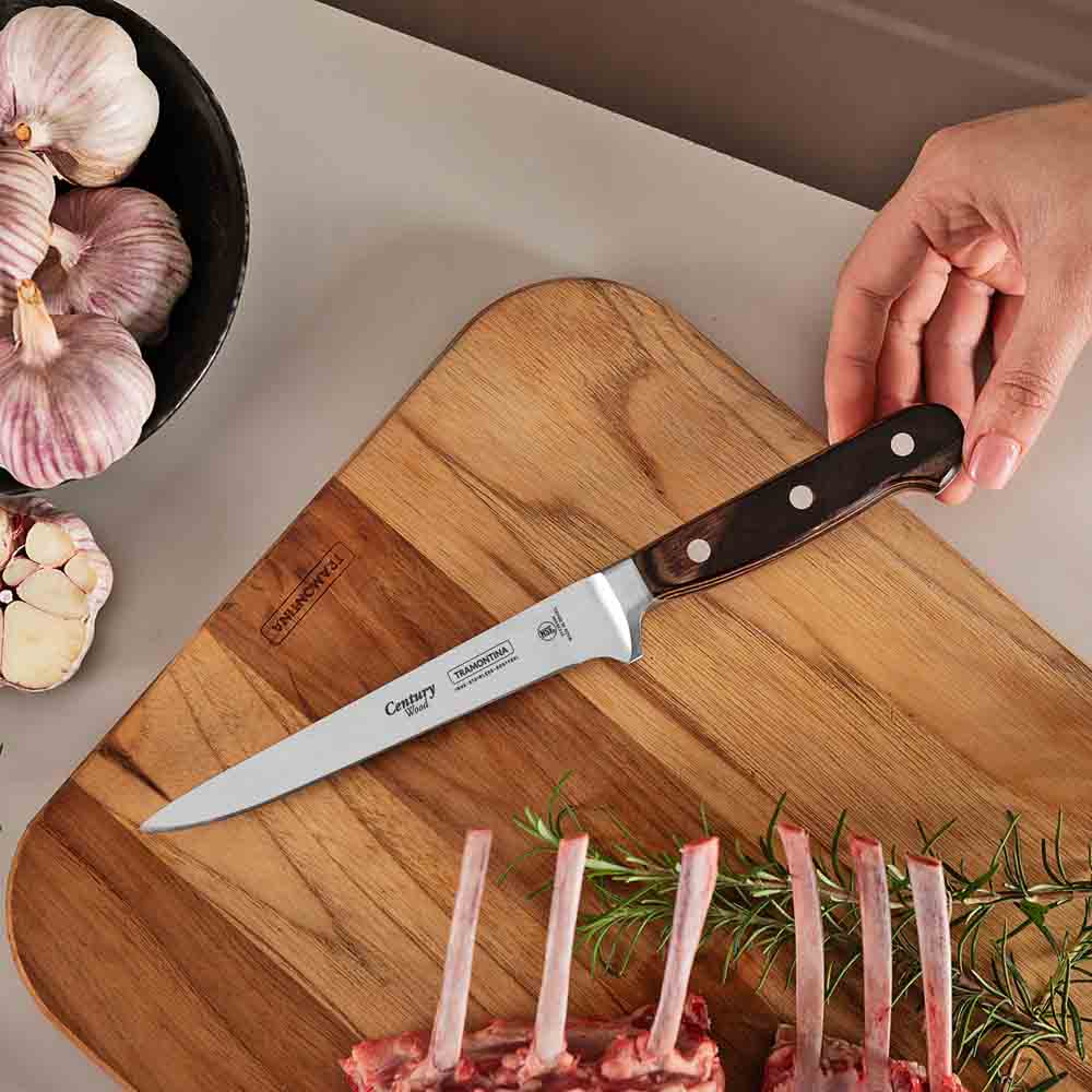 boning knife on chopping board with rack of lamb - House