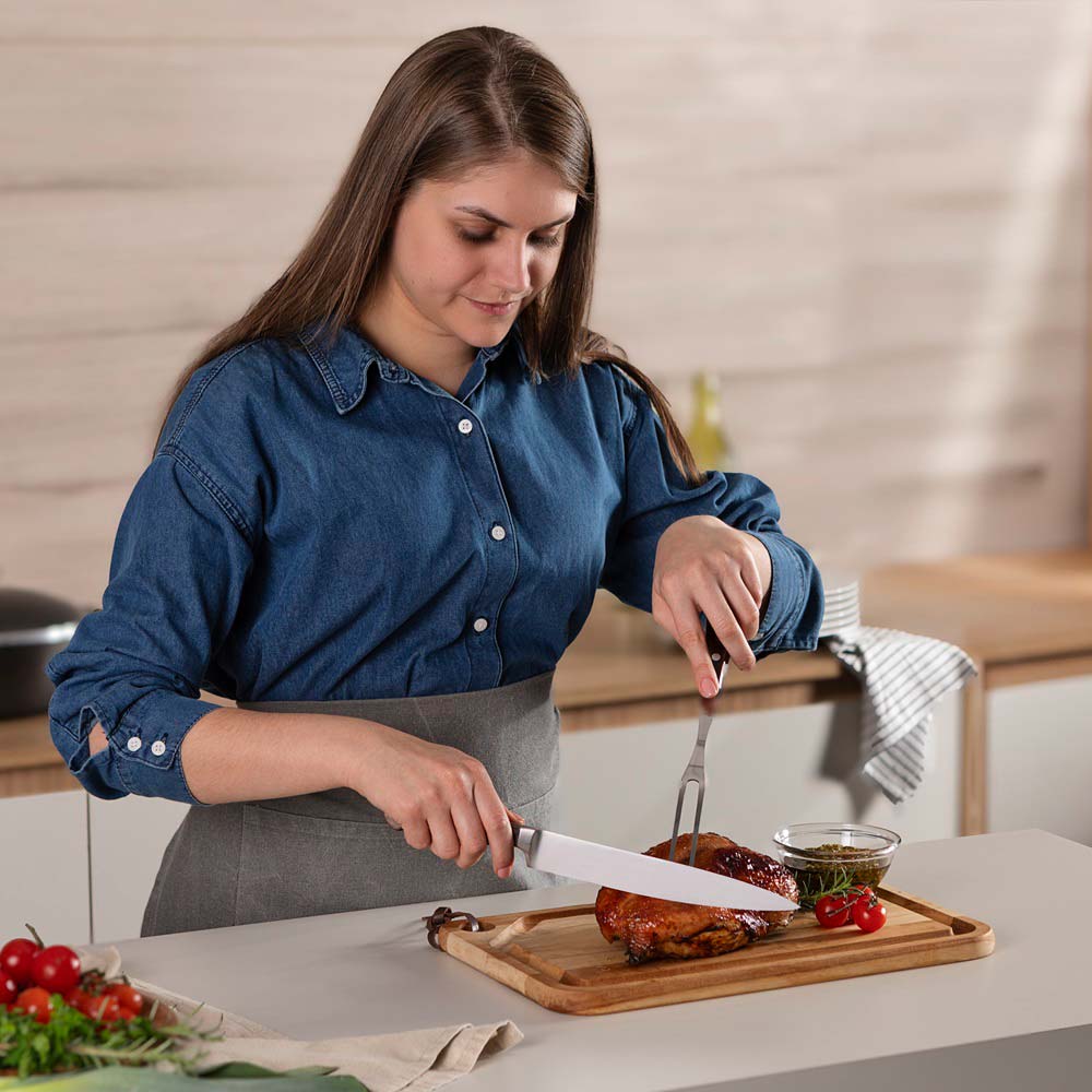 woman carving roast at kitchen bench with Utility Carving Knife - House