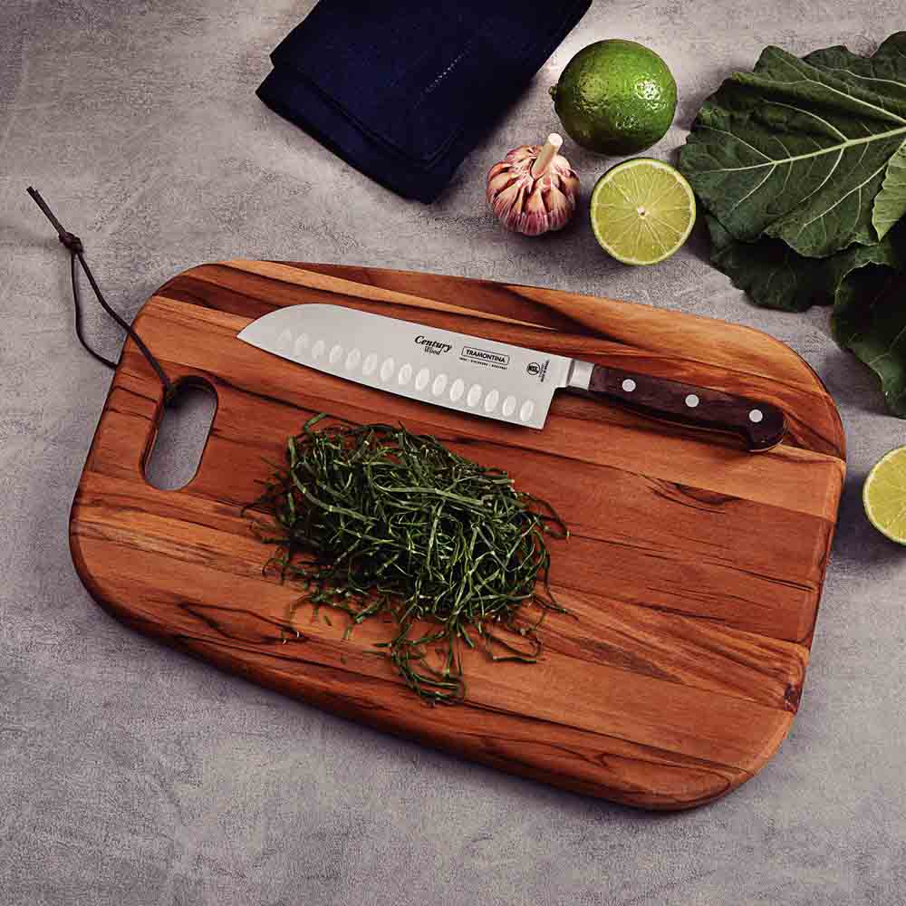 Santoku Knifeon wooden board with sliced vegetables- House