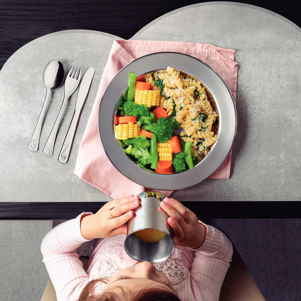 Child sitting at a table with meal and Baby Cutlery Set - House