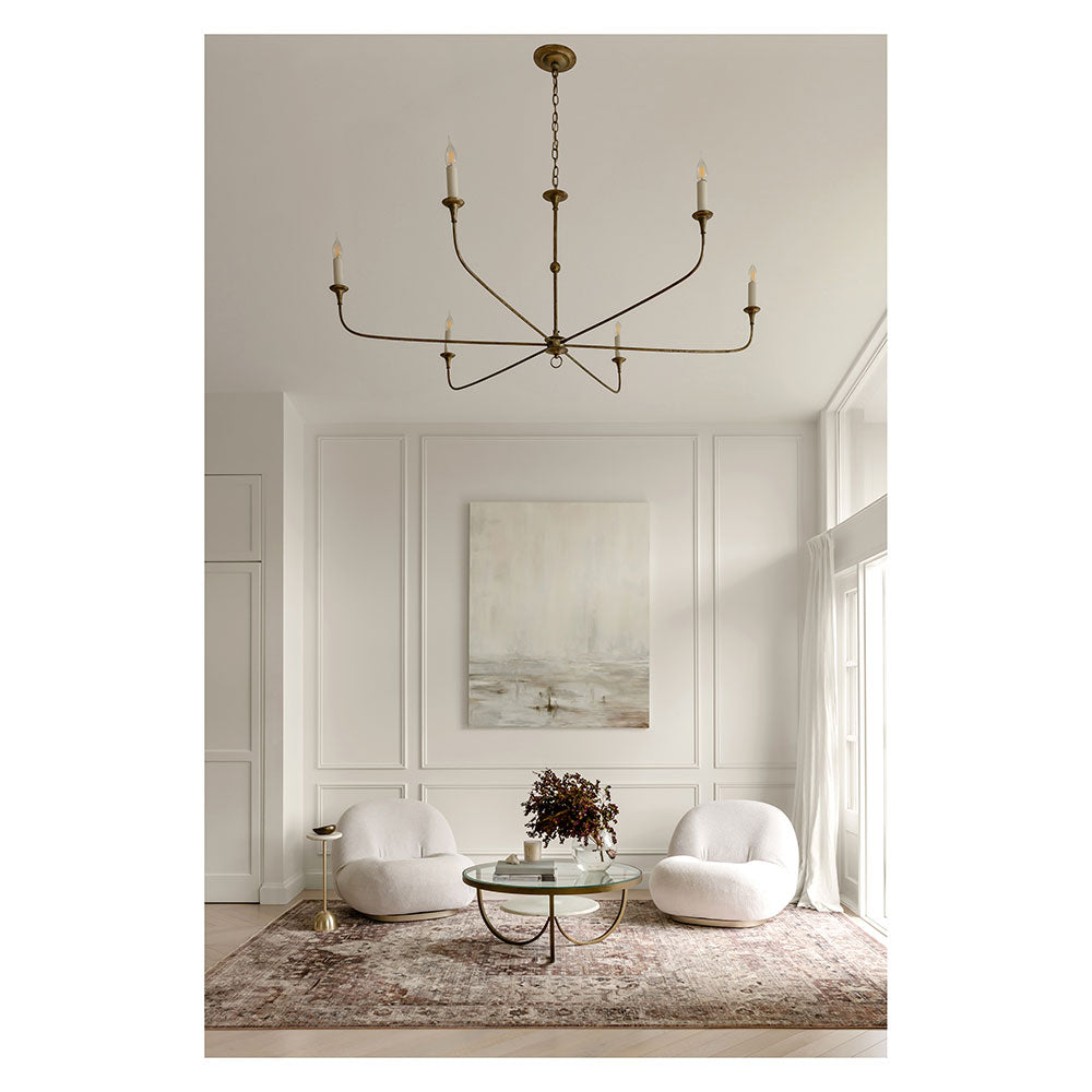 Darren Palmer Heirloom Rug in Plum in lounge room setting with large chandelier at House