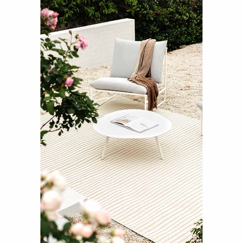 Darren Palmer Sandridge Indoor/Outdoor Rug in Cream outdoor setting on gravel path at House