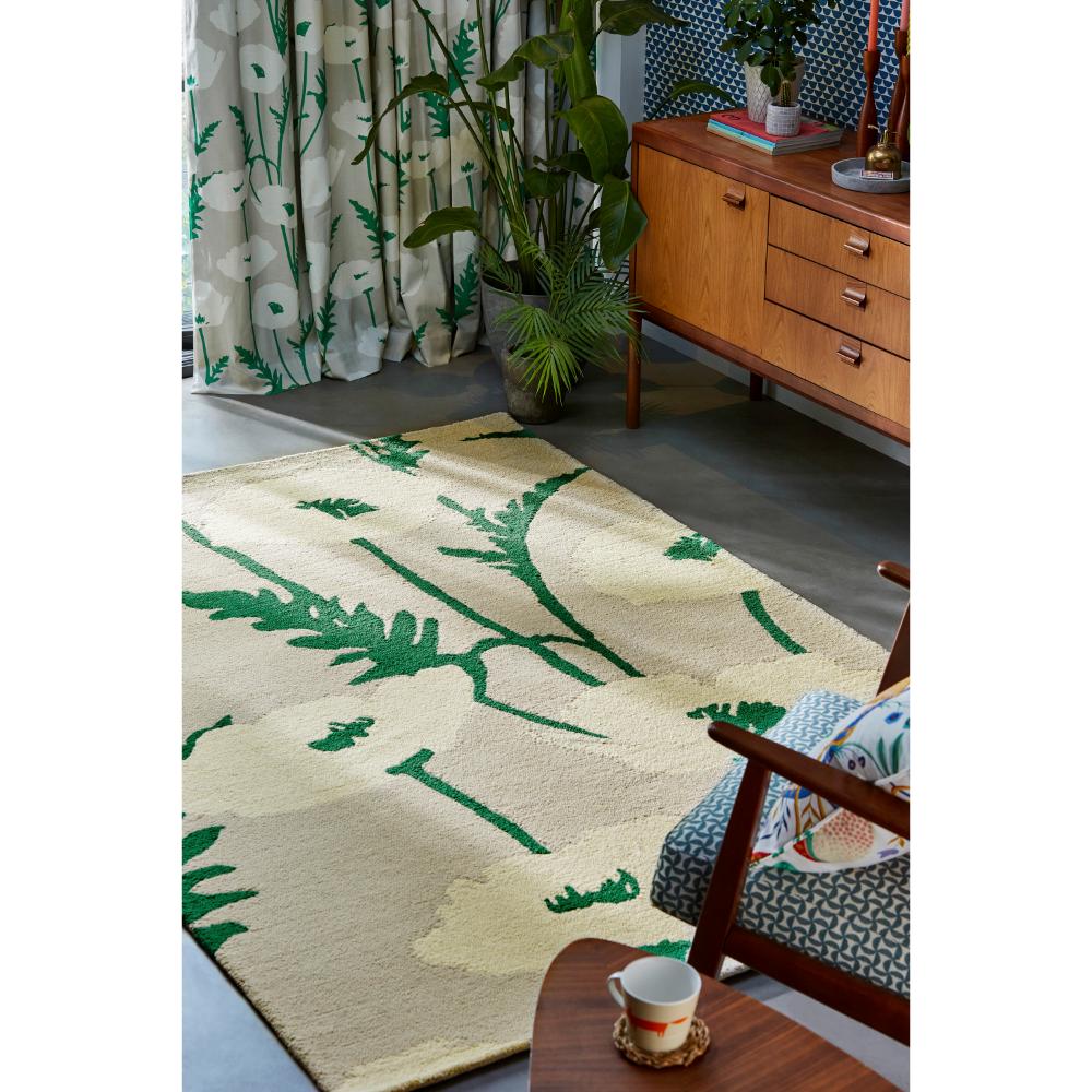 beige wool rug with cream poppies next to armchair - House