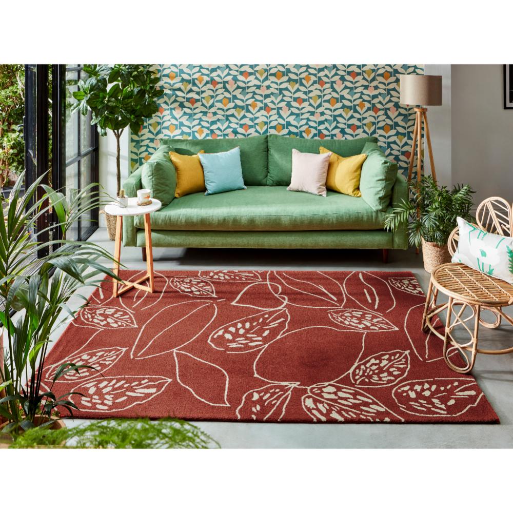 red leaf wool rug with green couch in loungeroom - House