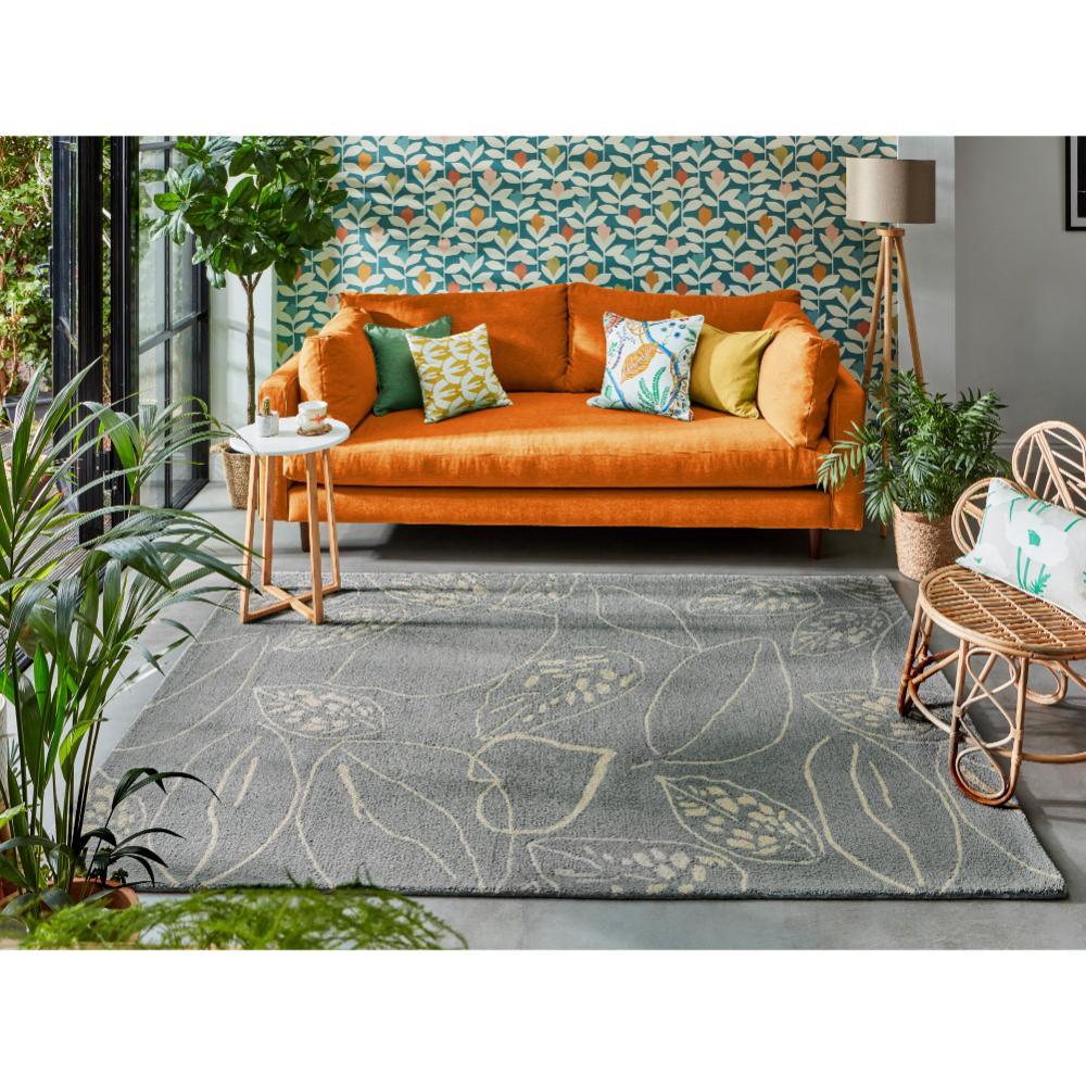 blue leaf wool rug with orange couch in loungeroom - House