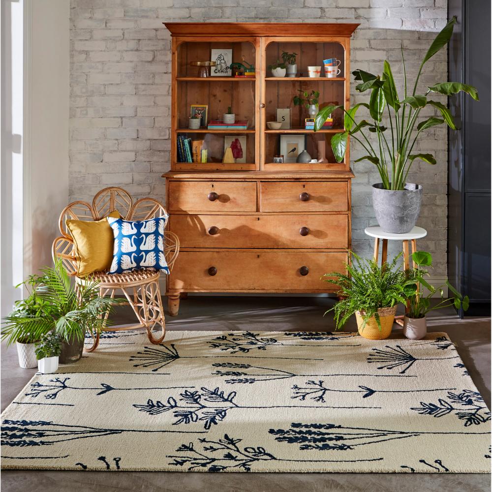 blue flower stem wool rug with plants and sitting room - House