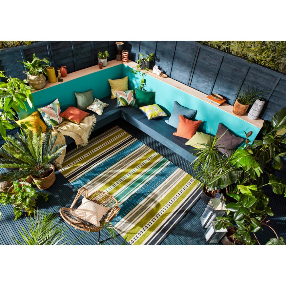 green and blue stripe indoor/outdoor rug on patio - House