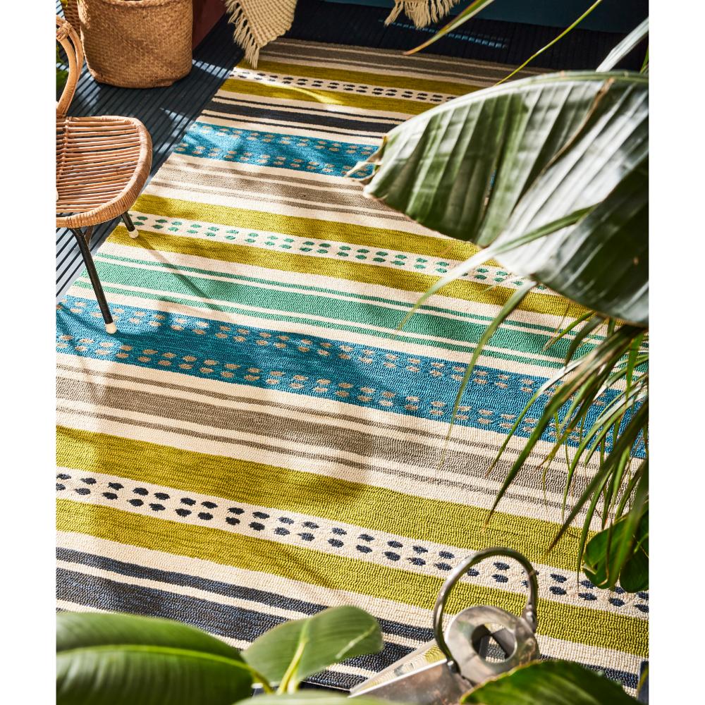 green and blue stripe indoor/outdoor rug on patio - House