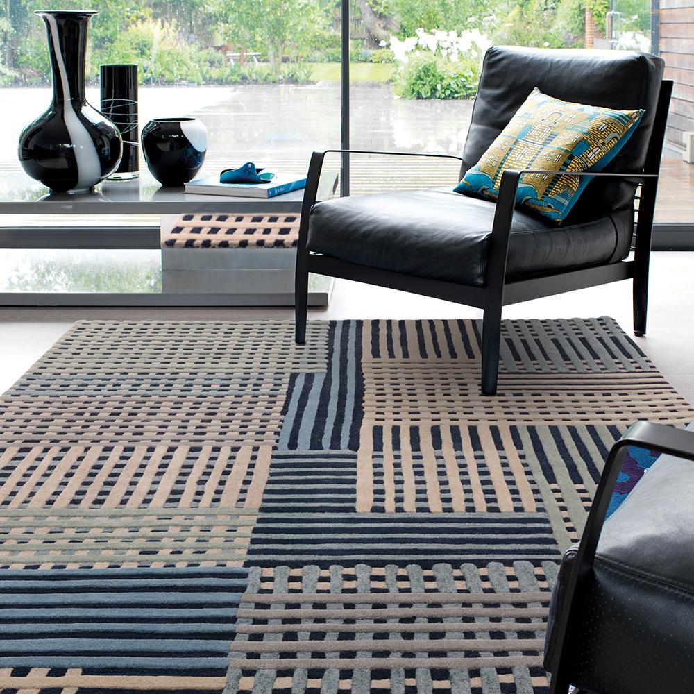 Wool basketweave design rug in blue with armchair