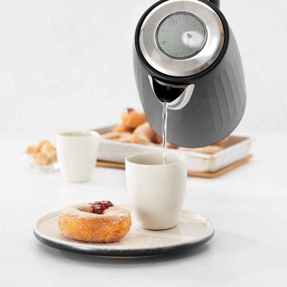 Baccarat The Boiling Point Kettle in Black at House. Black kettle pouring water into a mug.