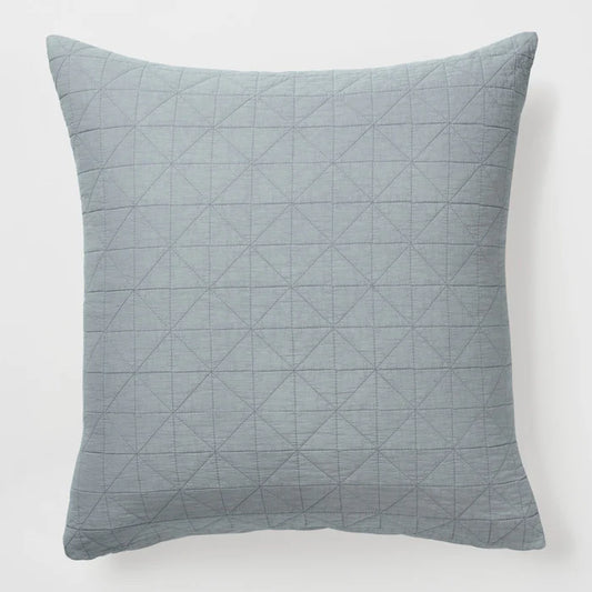 Quilted gray pillow on a white background