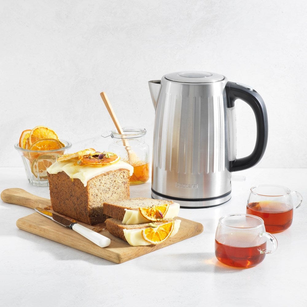 Baccarat The Boiling Point Kettle in Silver at House. Silver kettle with a side of orange and poppy seed cake and tea.